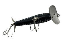 Load image into Gallery viewer, Belly View of 5/8 oz Fred Arbogast JITTERSTICK Vintage Fishing Lure in BLACK SHORE