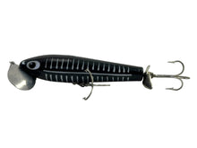 Load image into Gallery viewer, Left Facing View of 5/8 oz Fred Arbogast JITTERSTICK Vintage Fishing Lure in BLACK SHORE
