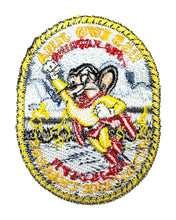 Load image into Gallery viewer, An oval embroidered patch featuring Mighty Mouse in a yellow and red outfit with mountains in the background and text around the border.
