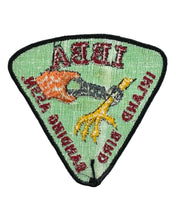 Load image into Gallery viewer, Picture of a hand actively banding a raptor claw. Patch back. IBBA
