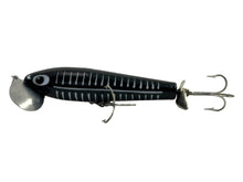 Load image into Gallery viewer, Left Facing View of 5/8 oz Fred Arbogast JITTERSTICK Vintage Fishing Lure in BLACK SHORE
