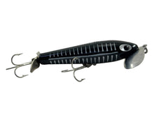 Lade das Bild in den Galerie-Viewer, Right Facing View of 5/8 oz Fred Arbogast JITTERSTICK Vintage Fishing Lure in BLACK SHORE
