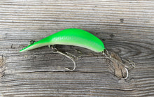 Load image into Gallery viewer, Left Facing Side View of HEDDON Phosphorescent MAGNUM TADPOLLY Fishing Lure in Original Vintage Heddon Geometric Box
